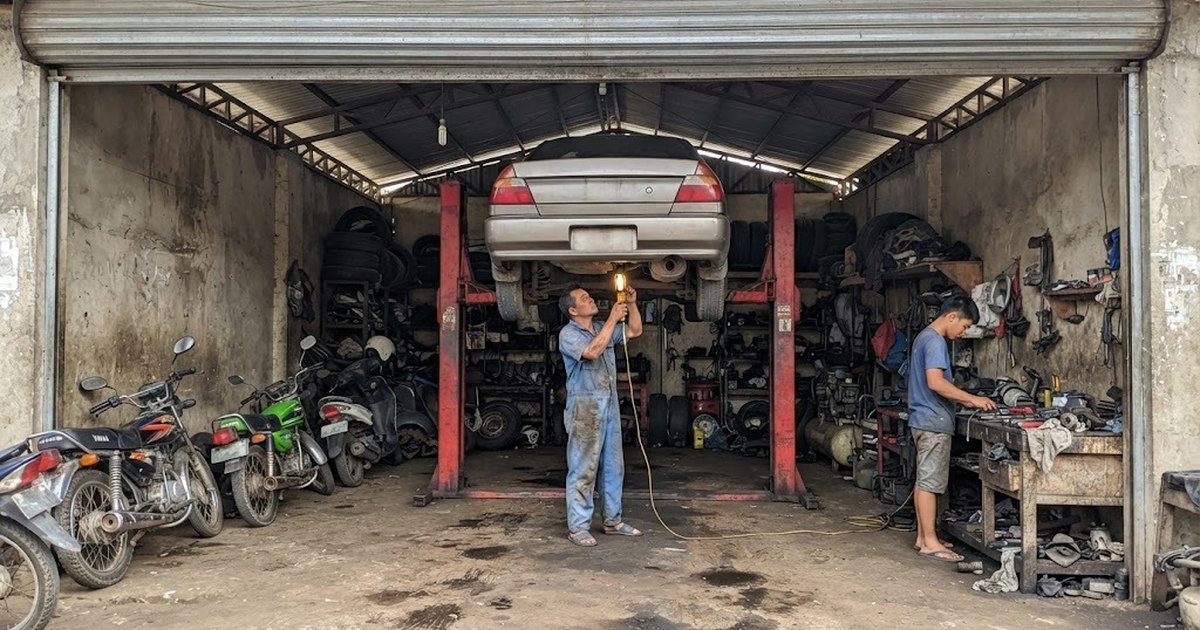 Mechanic checking a car raised on a two-post lift in a repair shop
