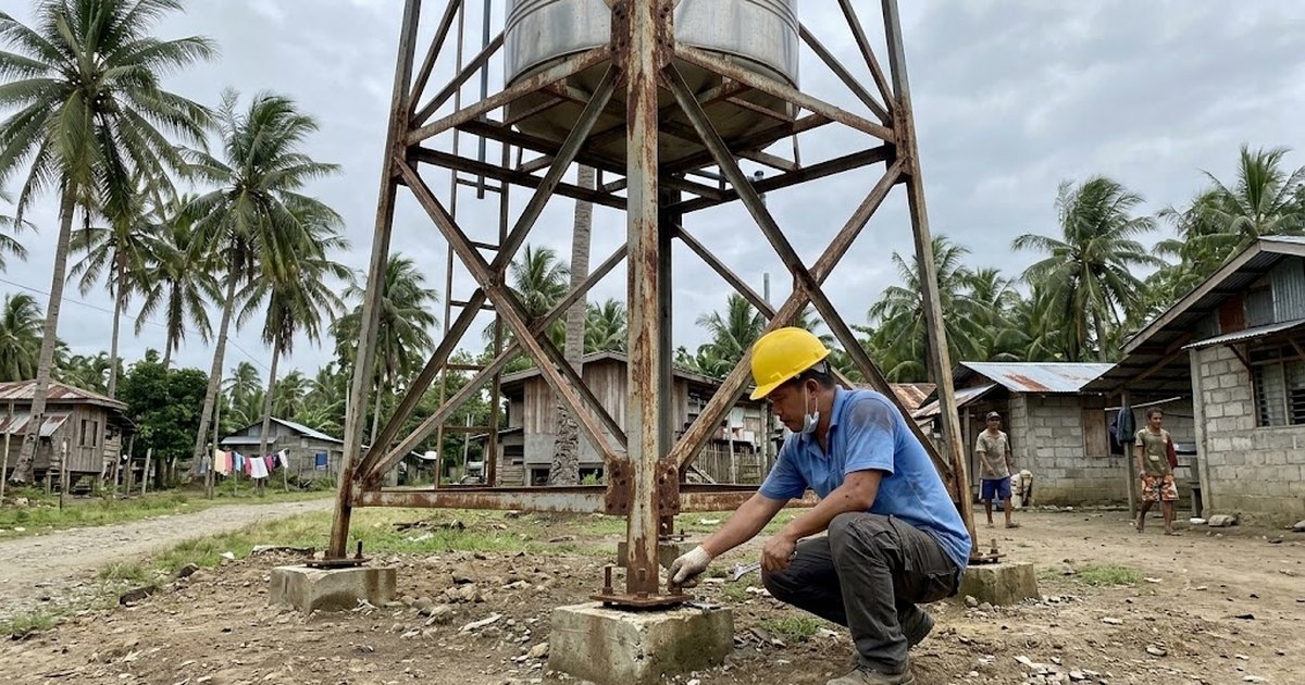 Engineer inspecting the base plate of an elevated steel water tank tower