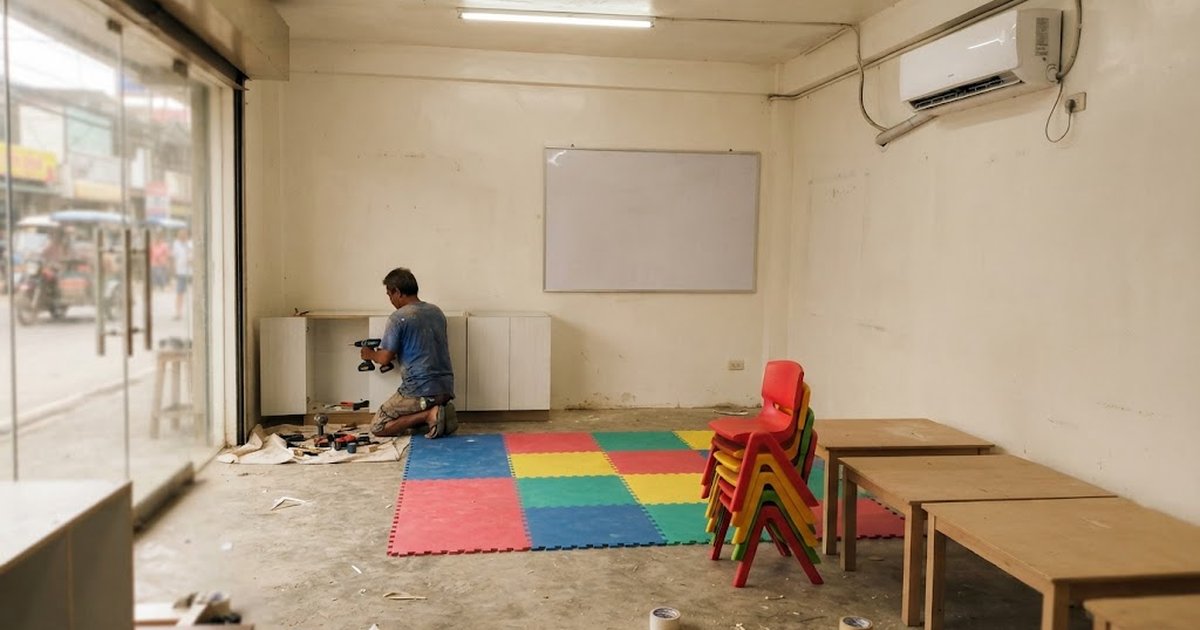 Carpenter installing low cabinets in a small learning center