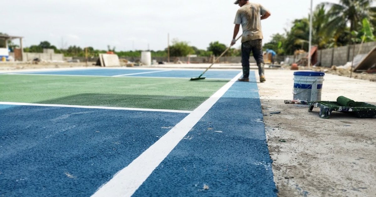 Freshly painted acrylic pickleball court surface on a concrete slab in the Philippines