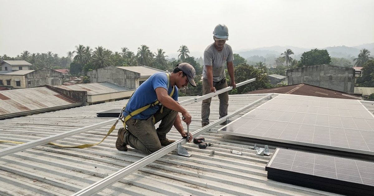 Solar panels mounted on the metal roof of a commercial building