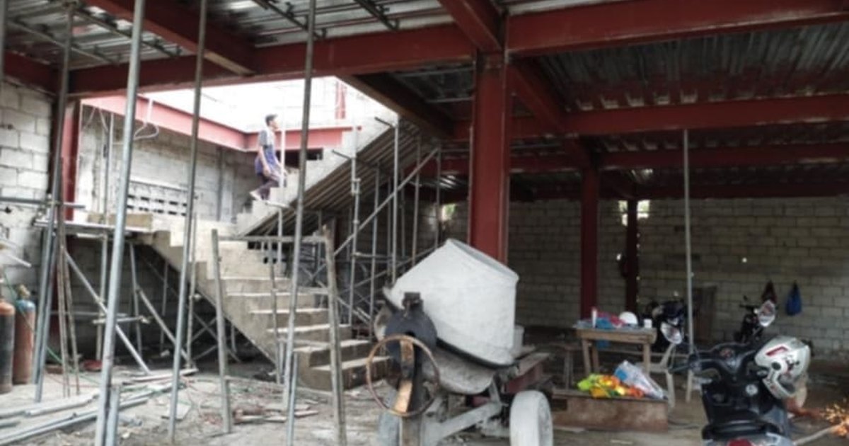 Unfinished concrete house shell standing exposed in the Philippines