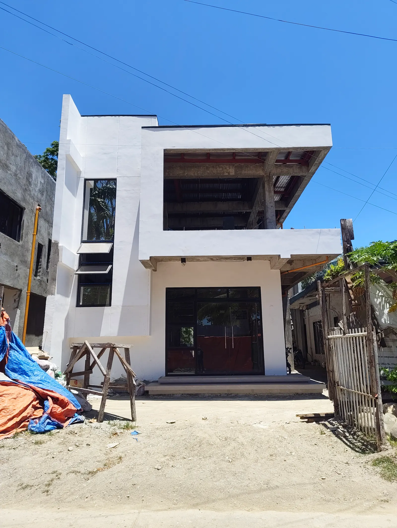 Exterior view of the completed GAD Building, a modern two-storey white structure — Manjuyod