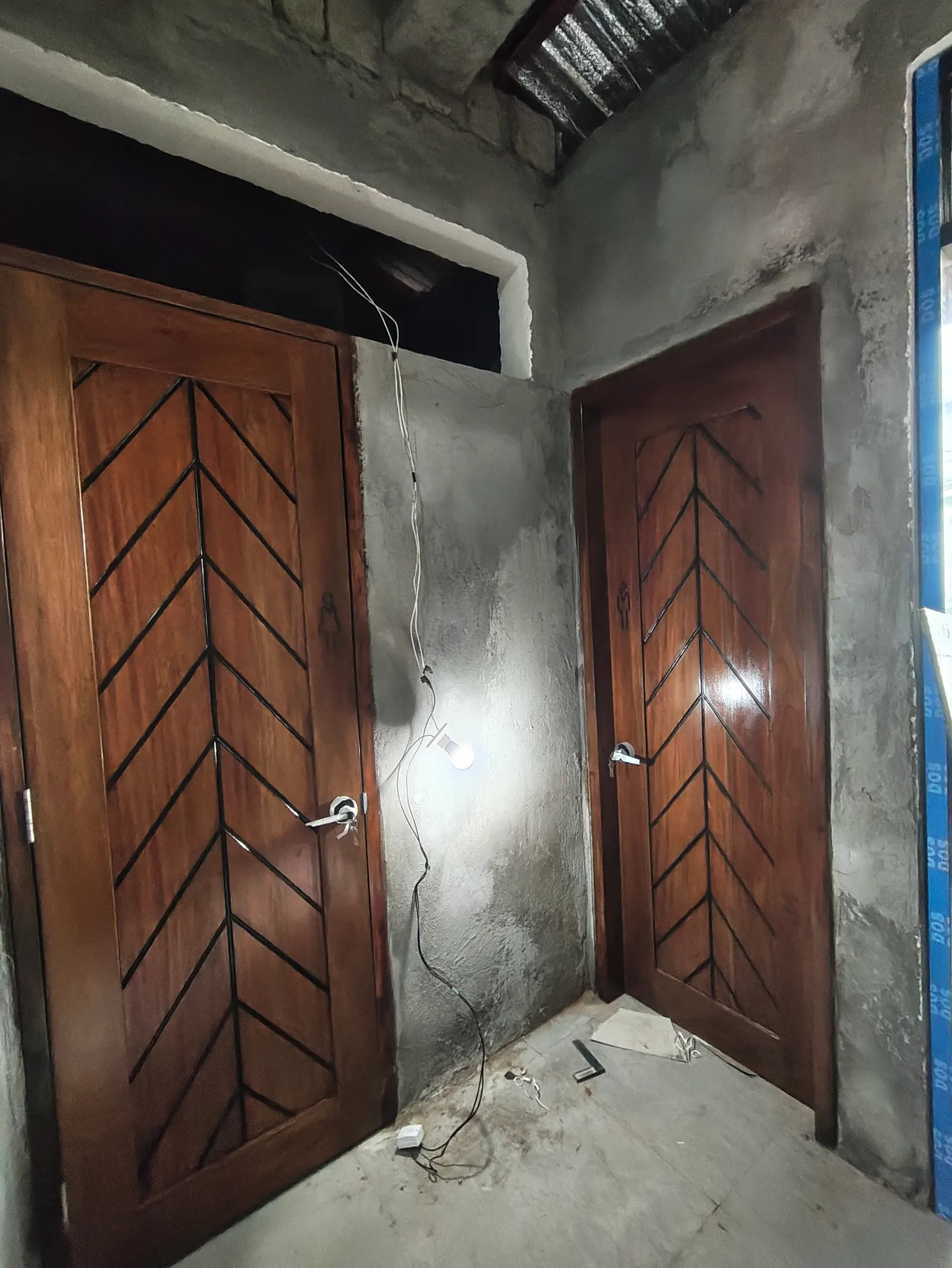 Finished restroom doors with wood-panel finish at the GAD Building — Manjuyod