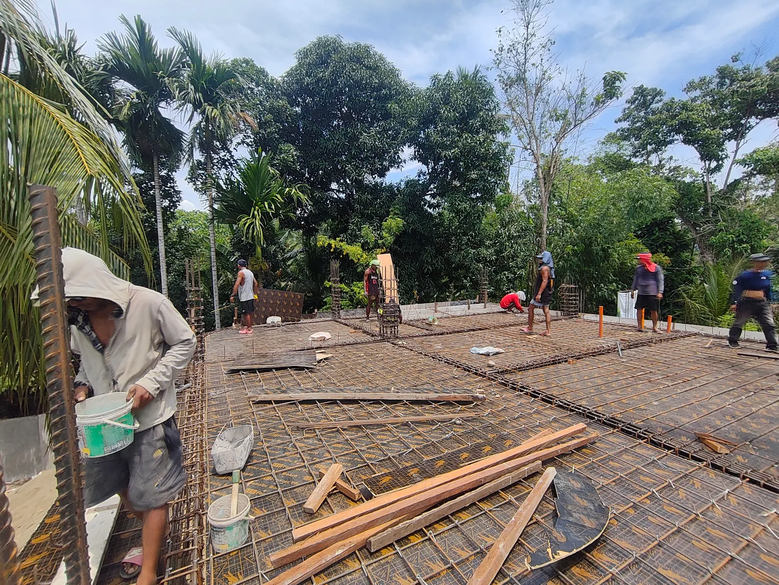 Reinforced concrete slab rebar grid laid out before concrete pour — two-storey house construction in Bohol, Philippines